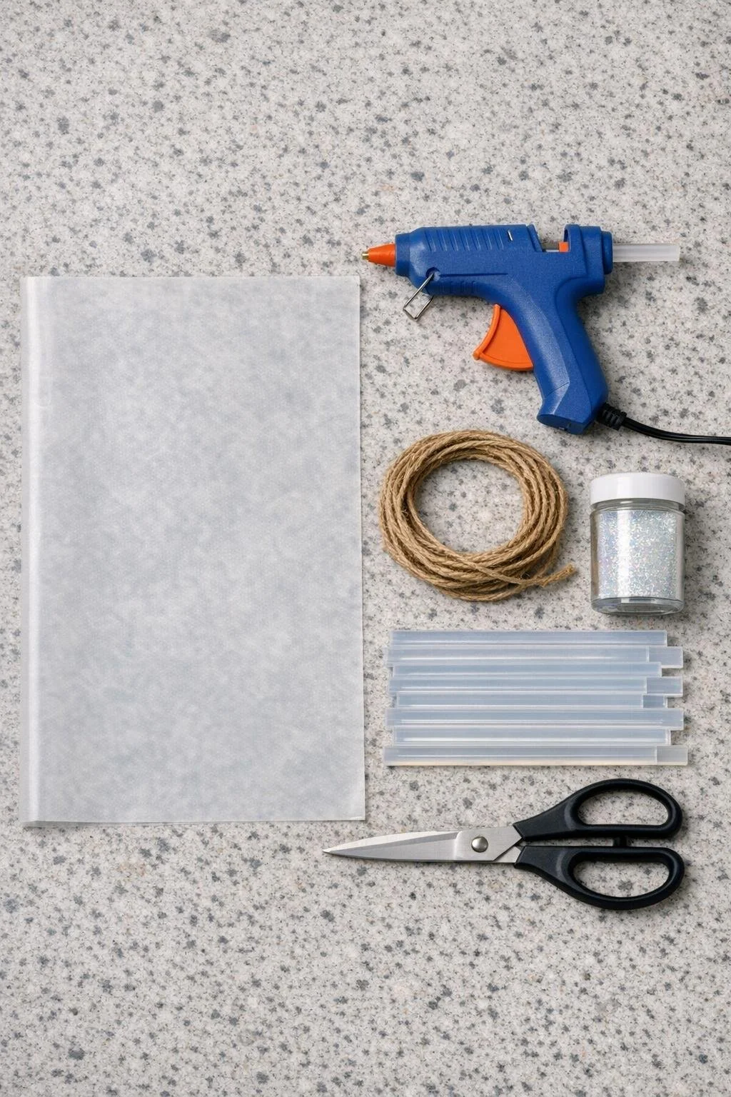 Materials for making a hot glue crystal icicle garland laid out on a counter