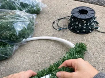 Wrap a hula hoop in dollar store garland, and the end result is spectacular